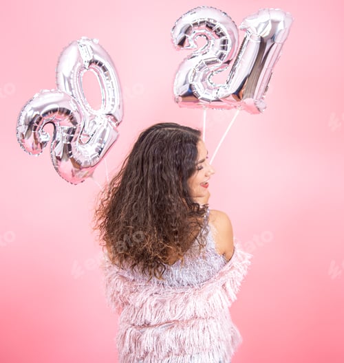 Preview: Girl on a pink background with silver balloons from the numbers 2021 in her hands