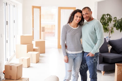 Preview: Portrait Of Loving Couple Surrounded By Boxes In New Home On Moving Day