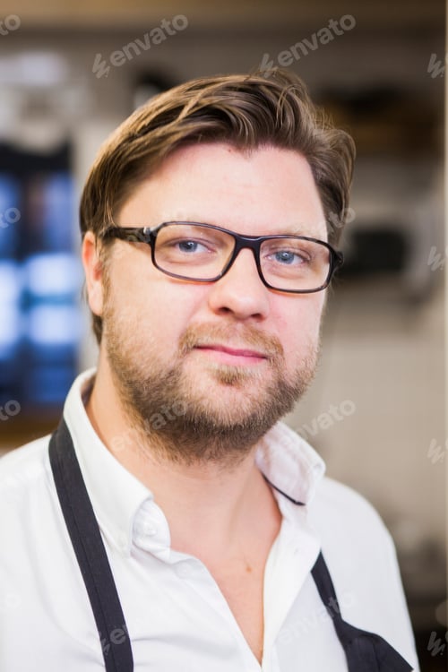 Preview: Portrait of confident chef at commercial kitchen