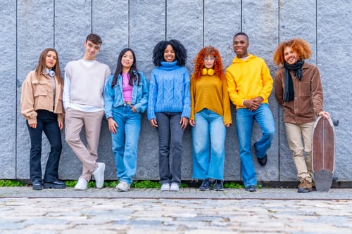 Preview: Multi-ethnic group of friends leaning on an urban wall