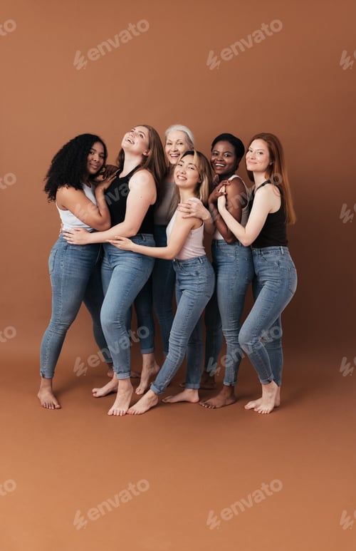 Preview: Group of cheerful women of different body type and ages standing together in a studio