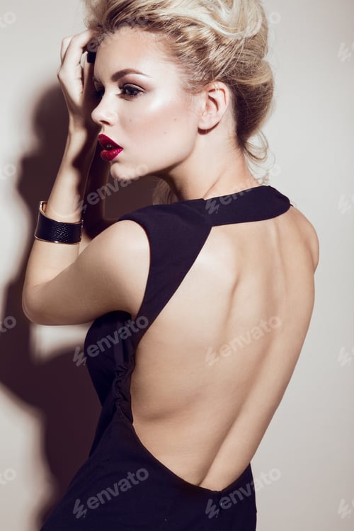 Preview: Beautiful sexy blonde girl with sensual lips, fashion hair, black dress and gold accessories.