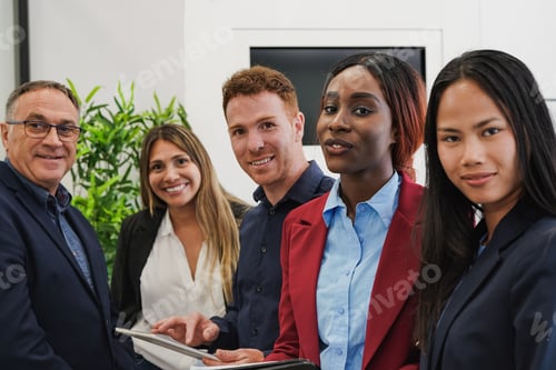 Preview: Multiracial business people smiling on camera while working inside modern office