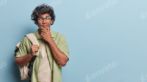 Preview: People emotions concept. Indoor shot of young thoughtful Hindu male student wearing white t shirt