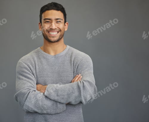 Preview: Shot of a handsome young man standing against a grey background