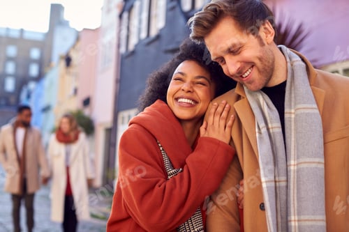 Preview: Multi Cultural Couple With Friends Walking Along Residential City Street In Fall Or Winter
