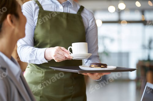 Preview: Asian female clerk working at a cafe