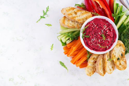 Preview: Roasted beet hummus with toast and vegetables on a light background