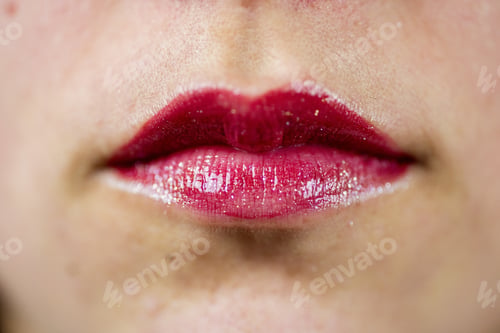 Preview: Closeup shot of a female's lips with a red lipstick