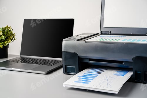 Preview: Printer and laptop on grey table in office