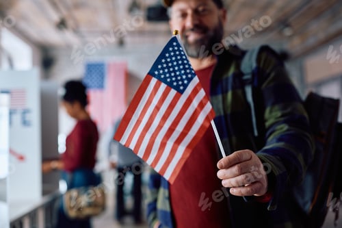 Preview: Close up of voter holding US flag at polling place.