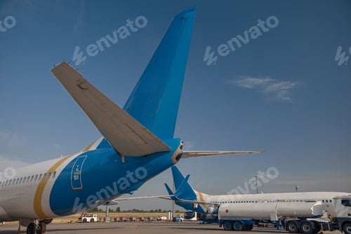 Preview: Two modern big airplanes in airport with blue sky in the background