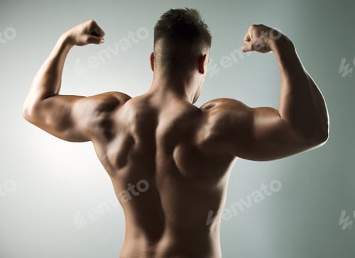 Preview: Intensity build immensity. Studio shot of a muscular young man posing against a grey background.