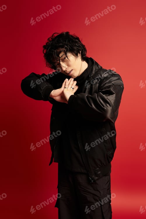 Preview: Enigmatic allure asian model strikes contemplative pose in studio against red