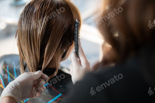 Preview: woman client person having a process to making treatment a hair with hairdresser in beauty salon