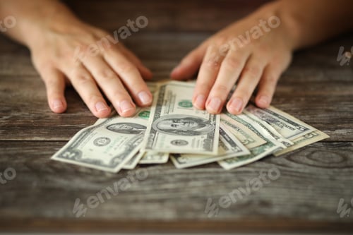 Preview: A woman counting money.