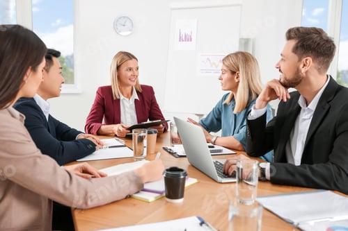 Preview: Businesswoman having meeting with her employees in office