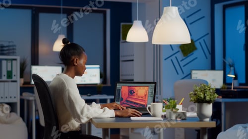 Preview: Dark skin gamer developer working at video game in midnight