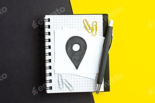 Preview: Top view of drawing on white blank on notebook on dark color yellow background with free space