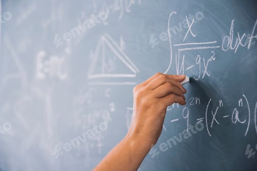 Preview: Teacher or student writing on blackboard during math lesson in school classroom