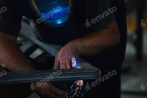 Preview: Skilled Technician Welding Metal Frames with Safety Equipment