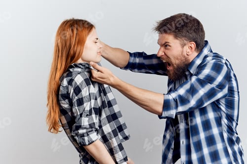 Preview: young couple in plaid shirts conflict communication relationship light background