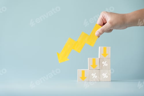 Preview: Yellow paper cut arrow going down negative trend on wooden blocks with percentages and human hand