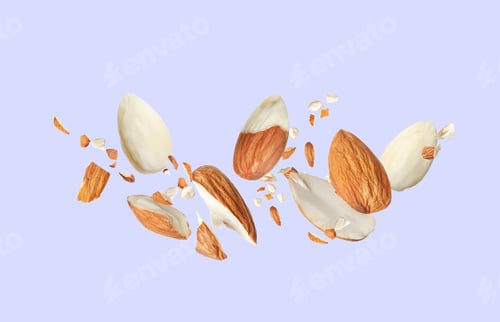 Preview: Pieces of tasty almonds falling on light grey background