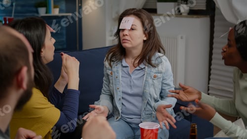 Preview: Multiracial friends enjoying friendship while playing guess who game