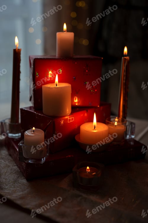Preview: Cozy holiday scene: glowing candles on red gifts with bokeh lights, golden decor, serene atmosphere.