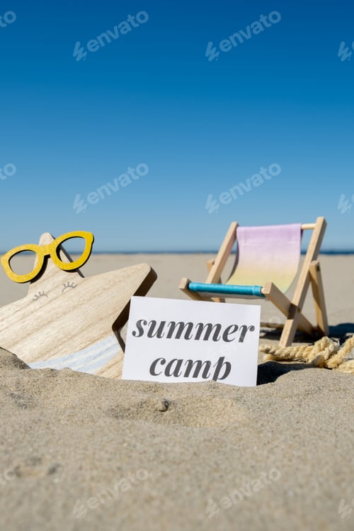 Preview: SUMMER CAMP text on paper greeting card on background of beach chair lounge starfish summer vacation