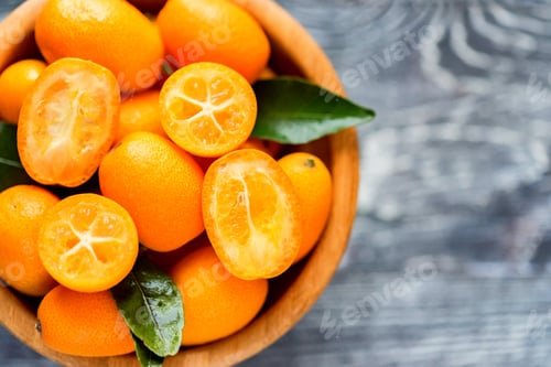 Preview: Kumquat or cumquat on wooden table