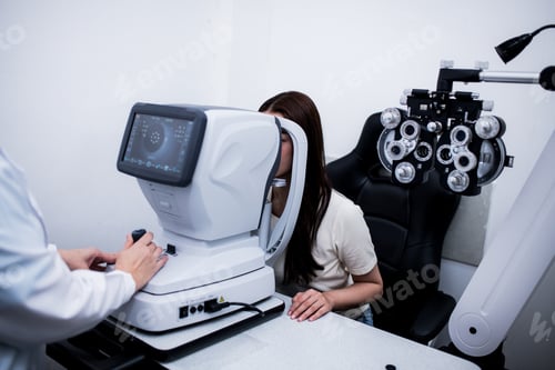 Preview: Woman optical shop customer doing eyesight measurement with optical phoropter check eye distance for