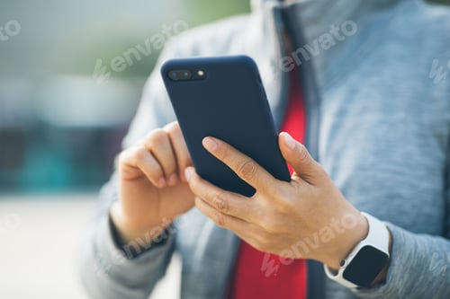Preview: Asian woman using smartphone at city