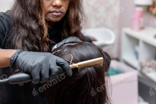 Preview: close up of african american female Student learning hairdresser with a mannequin head