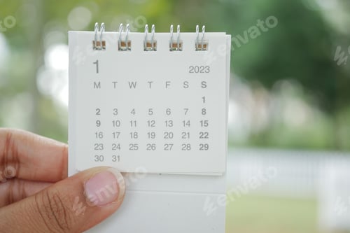 Preview: holding a 2023 year calendar on in nature