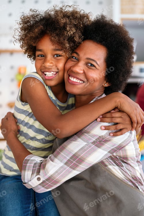 Preview: African american woman hugging her smiling teen daughter. Family love single parent child concept