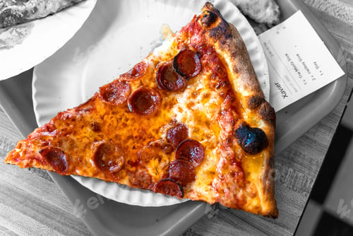 Preview: Top view of a freshly-made Hellboy Slice with melted cheese on the white plate