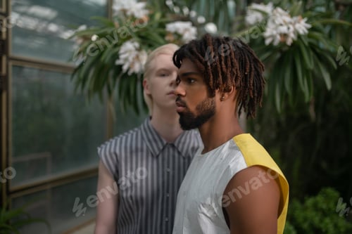 Preview: Bearded African American man with dreads standing near blonde man