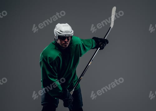 Preview: Portrait of hockey player isolated on grey background.