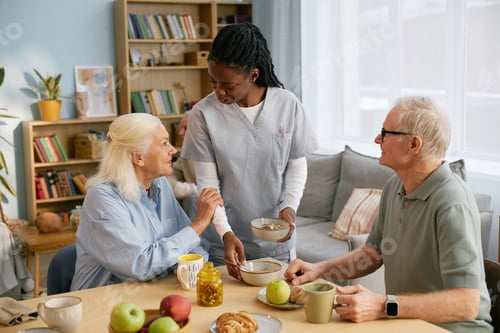 Preview: Elderly Couple Enjoying Breakfast With Caregiver