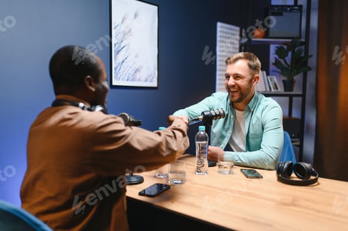 Preview: Podcasters shake hands after a good talk. Concept of podcasts and vlogs