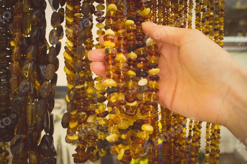 Preview: Vintage photo, Hand of woman with shiny womanly amber necklaces on stall