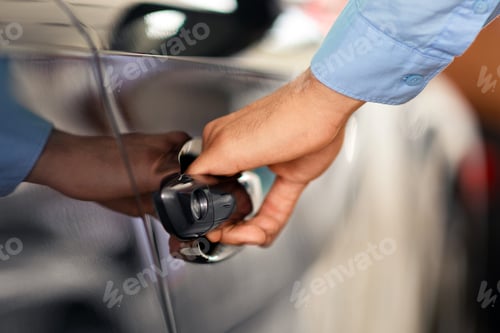 Preview: Man open car door, making test drive at showroom, cropped
