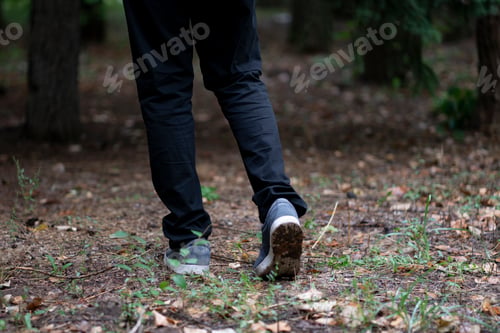 Preview: close up feet of a person walking in the forest, trail hiking