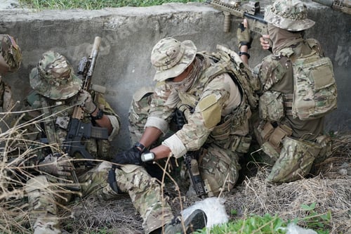 Preview: Soldier in full US MARSOC armed with assault rifle run through the abandoned building. Military