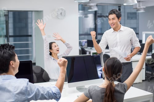 Preview: Young business people cheering in office
