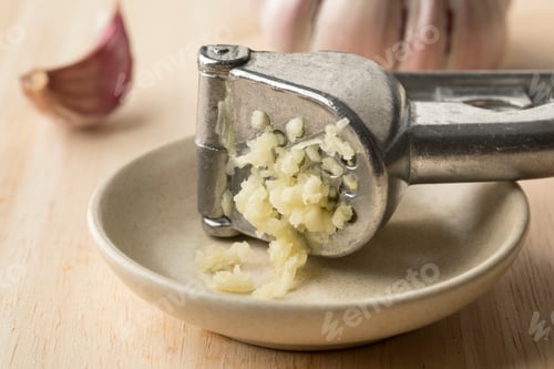 Preview: Garlic crushed in a press