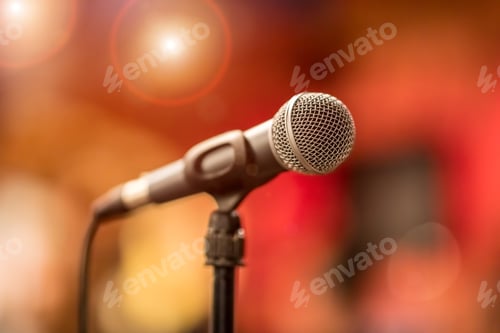Preview: Microphone on stage against a background of auditorium.