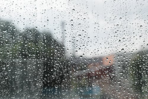 Preview: Raindrops on the surface of window, cloudy rainy weather, defocus city background